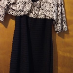 Black and white knee lengthed dress with lightweight jacket. Sparkle detail.